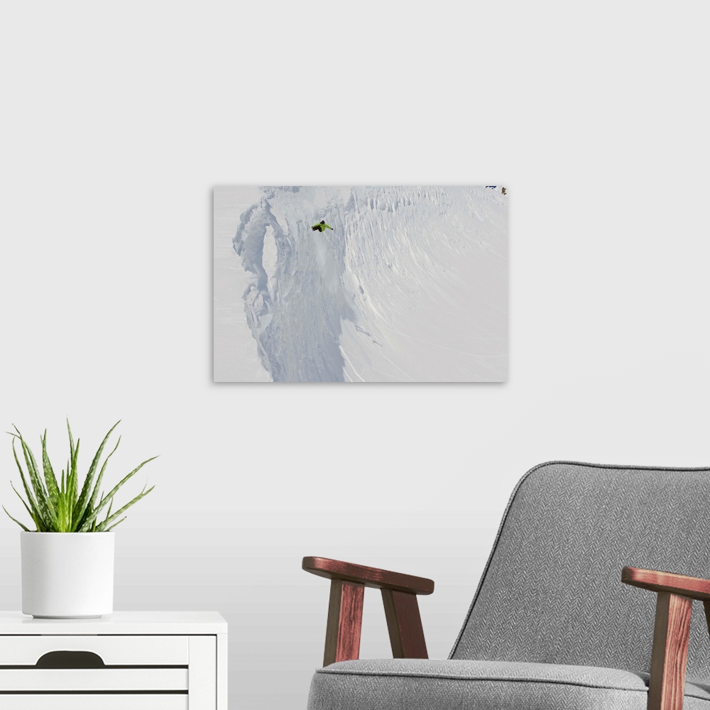 A modern room featuring Professional snowboarder, Kevin Pearce, extreme heli boarding in the mountains above Haines, Alaska.