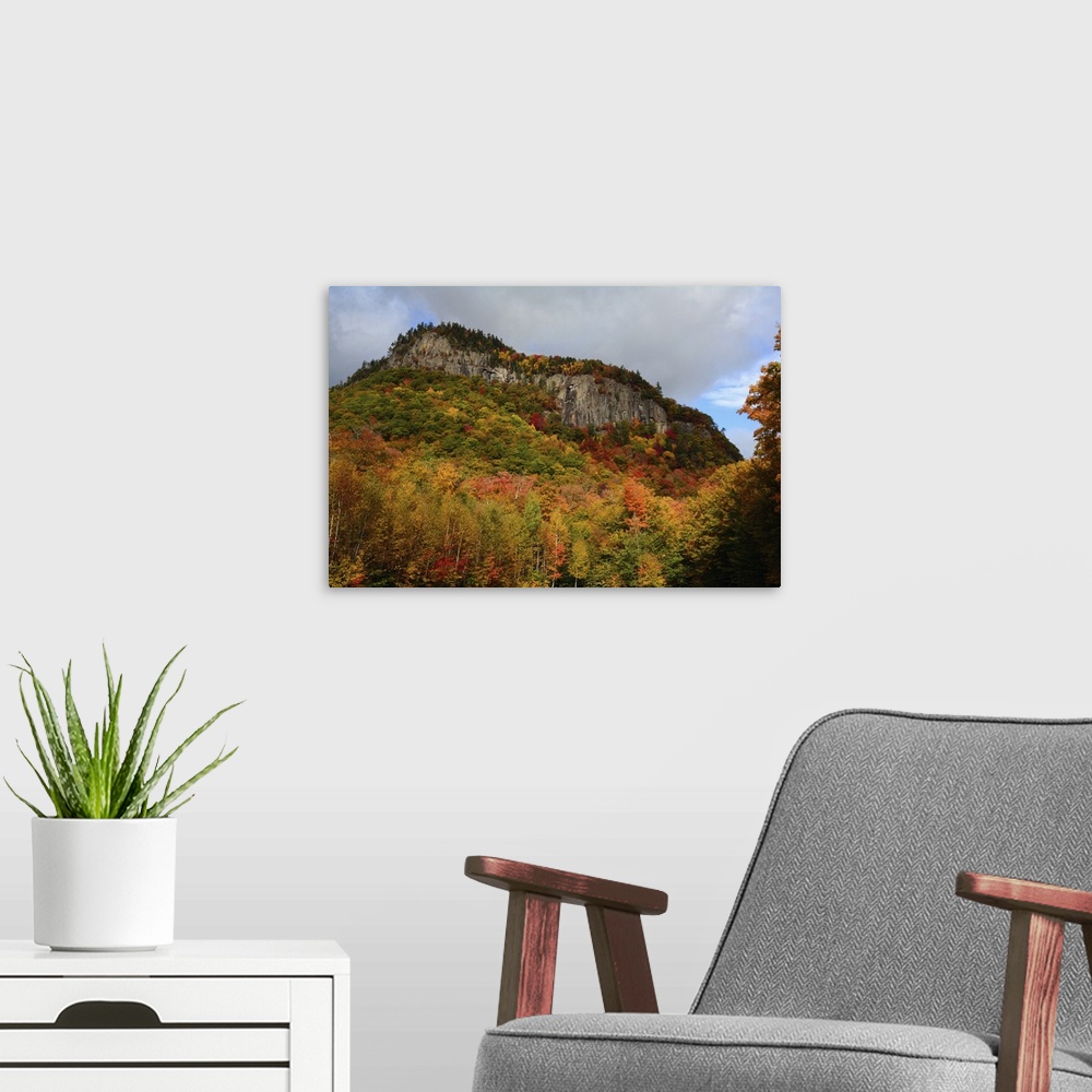 A modern room featuring Scenic view of fall foliage and exposed rock on a hillside in the White Mountains, New Hampshire....