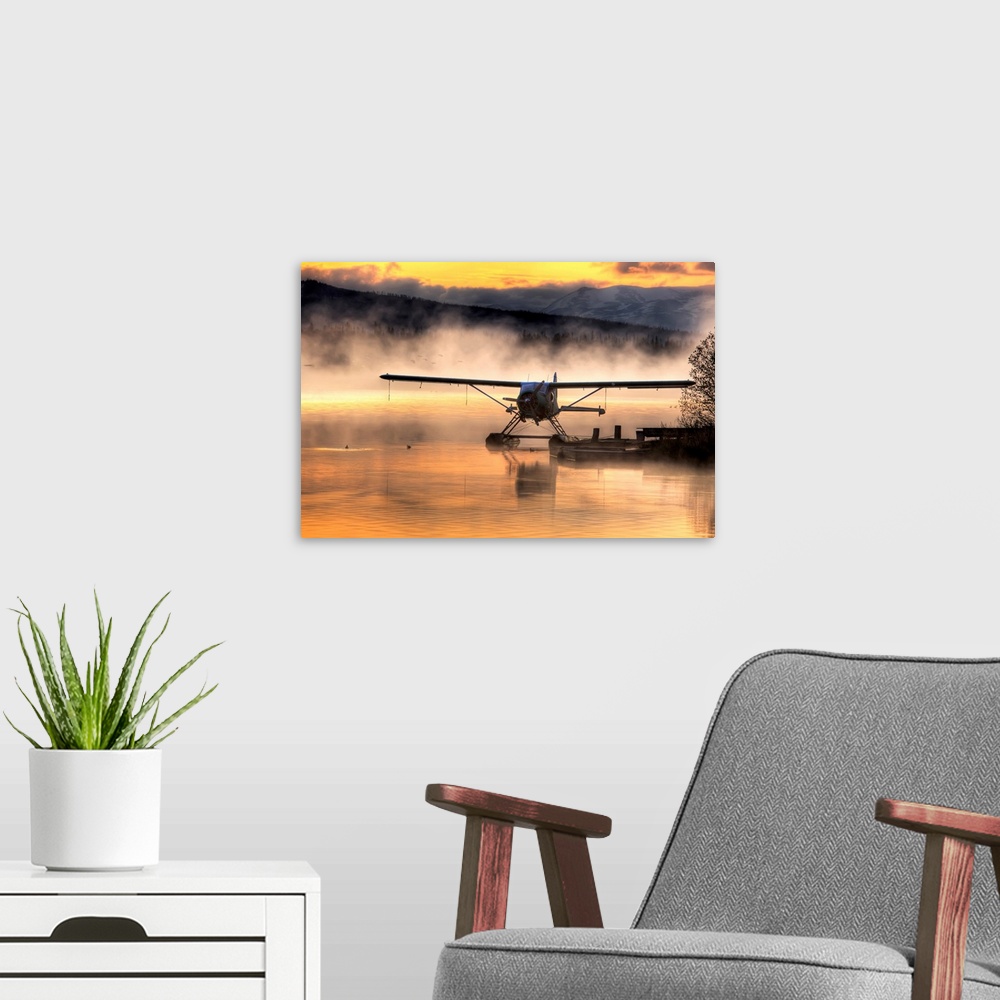 A modern room featuring Giant photograph displays a seaplane sitting next to a dock as a soft fog rolls over the water.  ...