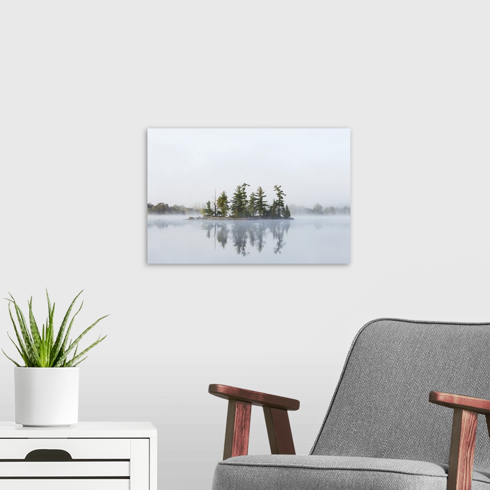 A modern room featuring Fog shrouds a small island on Turtle Lake in Ontarios Muskoka Region, near Rosseau; Ontario, Canada