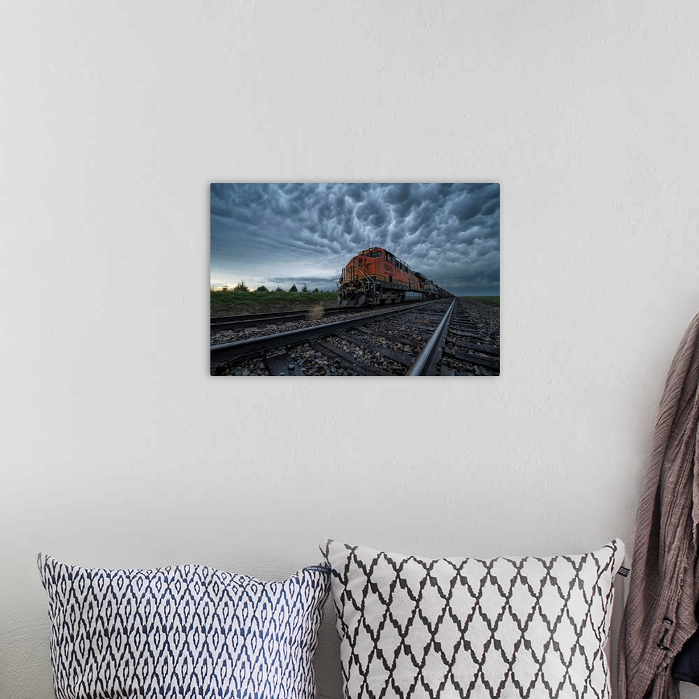 A bohemian room featuring Freight train with mammatus clouds overhead while on a storm chasing tour; Oklahoma, United State...