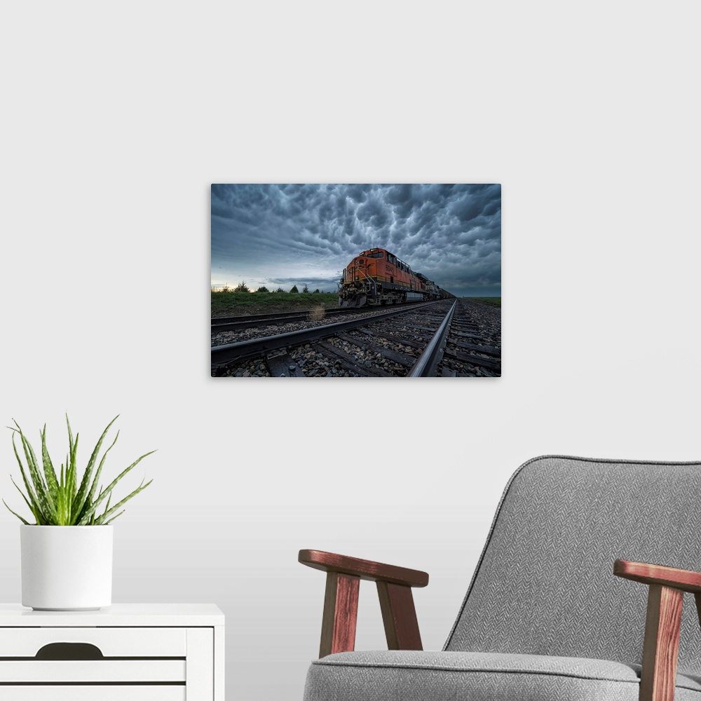 A modern room featuring Freight train with mammatus clouds overhead while on a storm chasing tour; Oklahoma, United State...