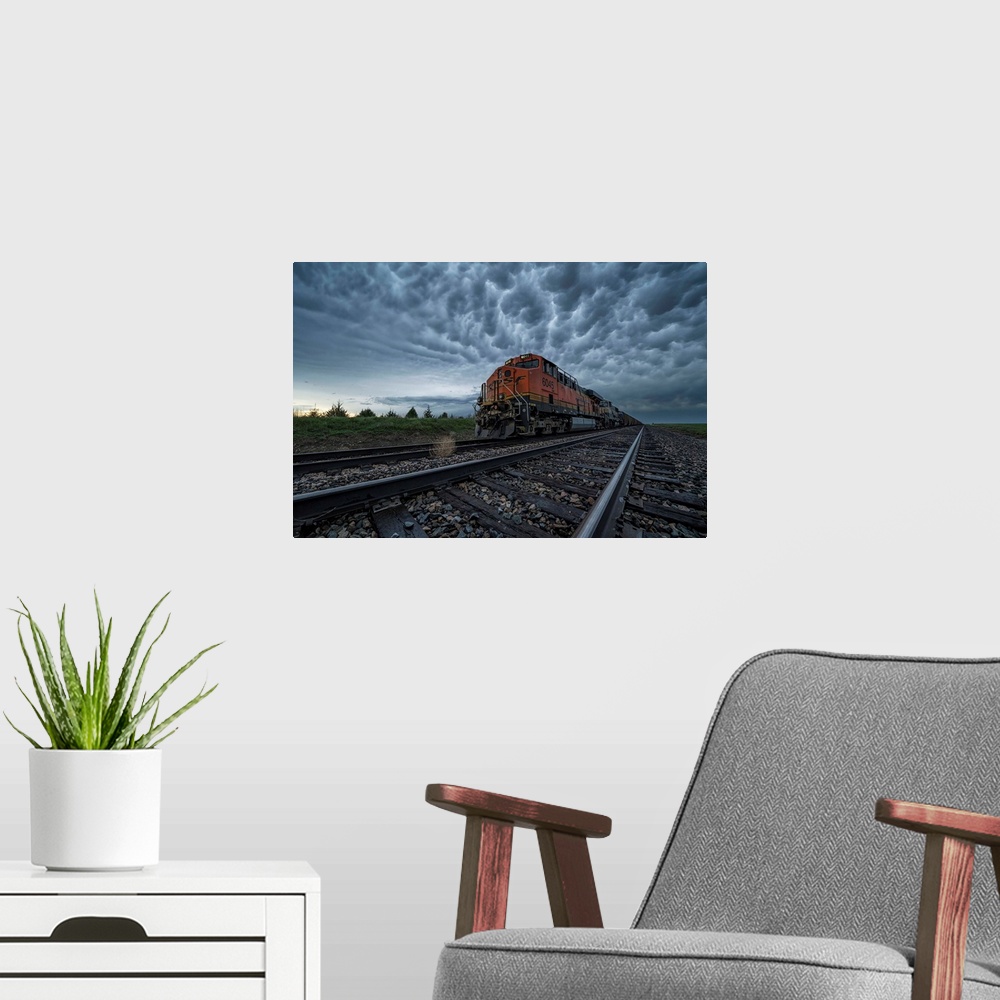 A modern room featuring Freight train with mammatus clouds overhead while on a storm chasing tour; Oklahoma, United State...