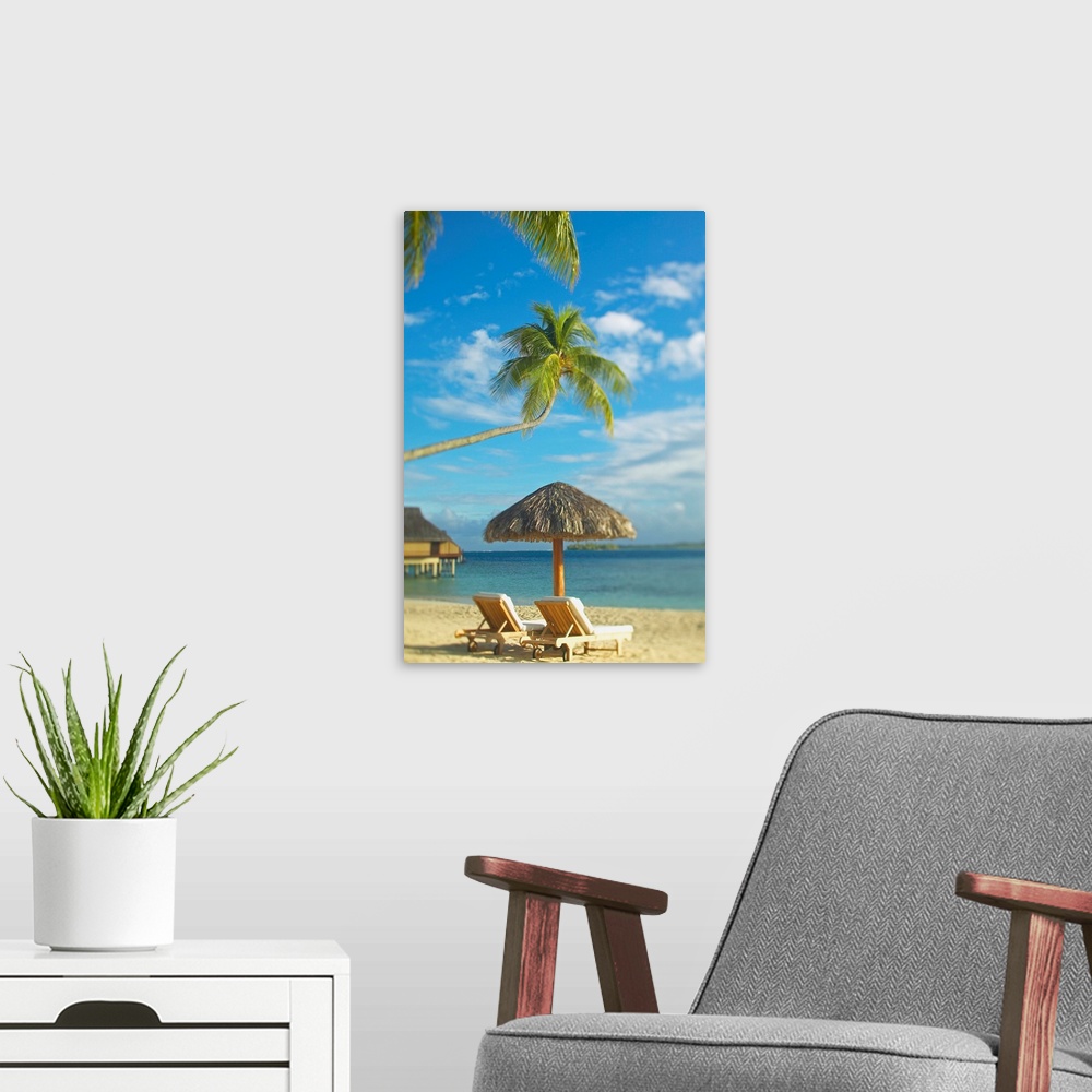 A modern room featuring Photograph taken of two beach chairs and an umbrella sitting on a beach in Tahiti. A palm tree st...
