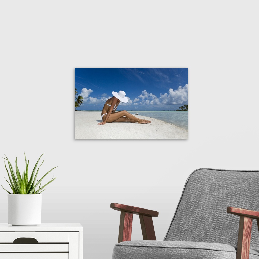 A modern room featuring French Polynesia, Tuamotu Islands, Rangiroa Atoll, Woman Sitting On White Sand Beach