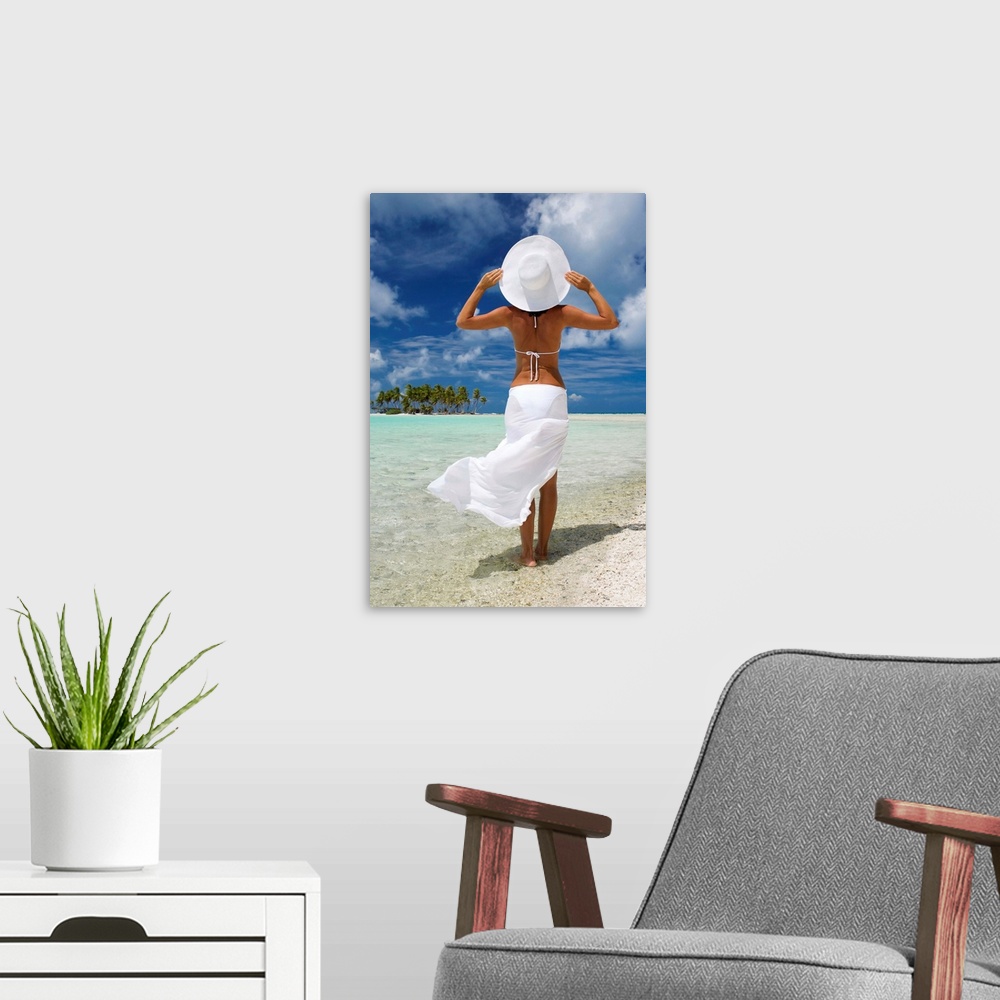A modern room featuring French Polynesia, Tuamotu Islands, Rangiroa Atoll, Woman Standing At Ocean's Edge