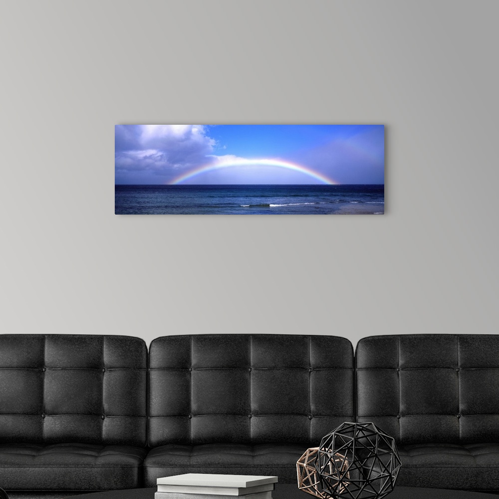 A modern room featuring Full Rainbow Over Ocean, Large Clouds Against Blue Sky