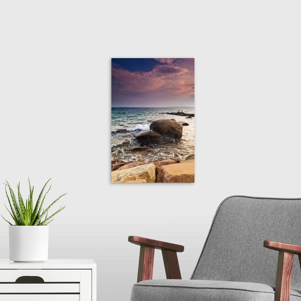 A modern room featuring Glowing pink clouds at sunset and rocks along the coast, Falmouth, Massachusetts