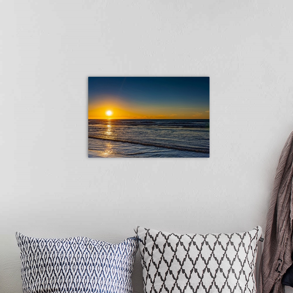 A bohemian room featuring Golden sunset over the Pacific ocean, viewed from the North shore; New Zealand