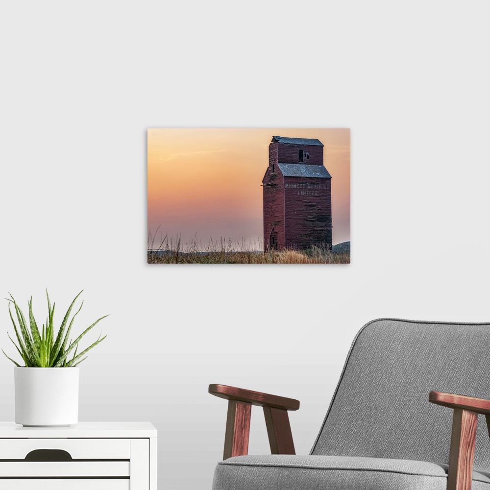 A modern room featuring Abandoned and weathered grain elevator at sunset on the Canadian Prairies; Val Marie, Saskatchewa...