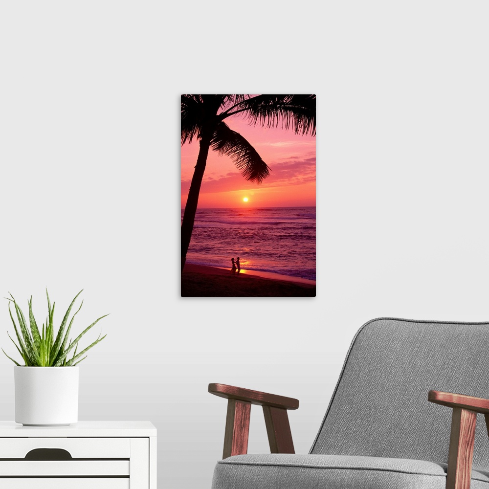 A modern room featuring Hawaii, Couple Silhouetted On The Beach At Sunset With Tall Palm Foreground