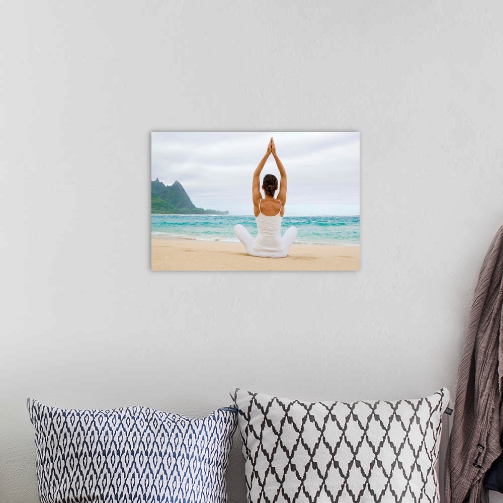 A bohemian room featuring Hawaii, Kauai, Haena Beach, Woman Meditating On Sandy Shore