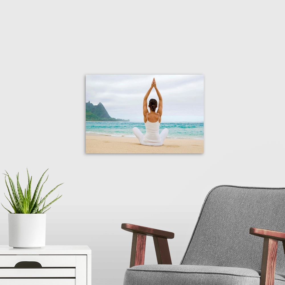 A modern room featuring Hawaii, Kauai, Haena Beach, Woman Meditating On Sandy Shore