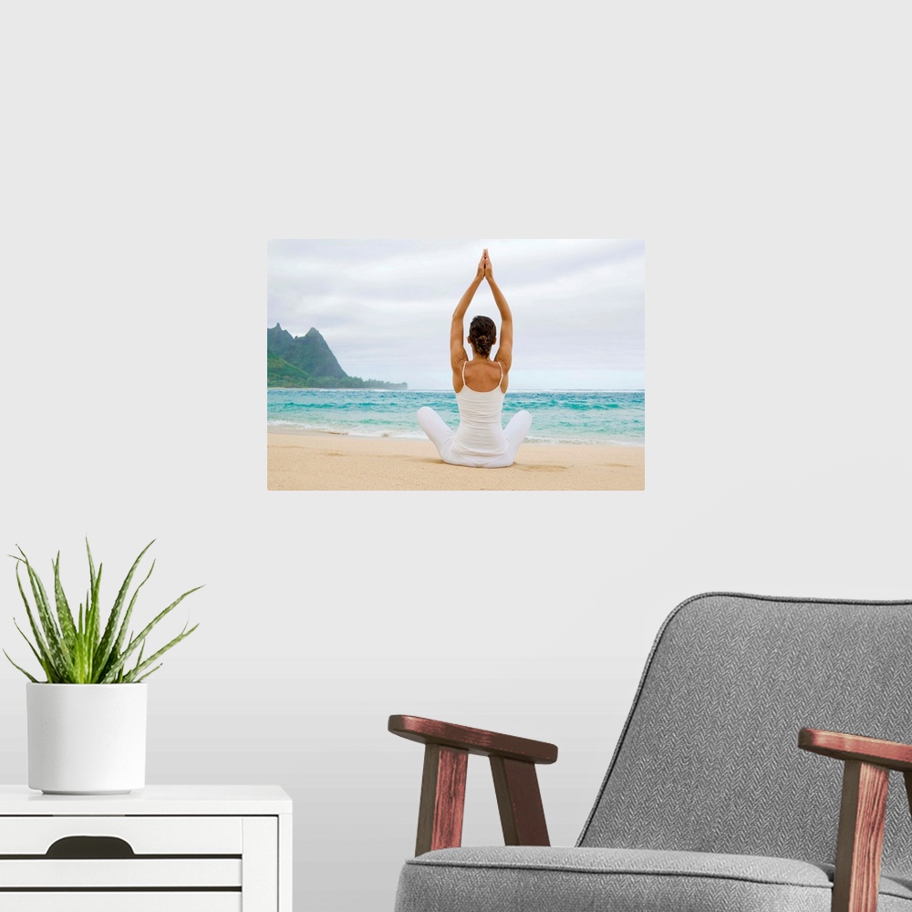 A modern room featuring Hawaii, Kauai, Haena Beach, Woman Meditating On Sandy Shore