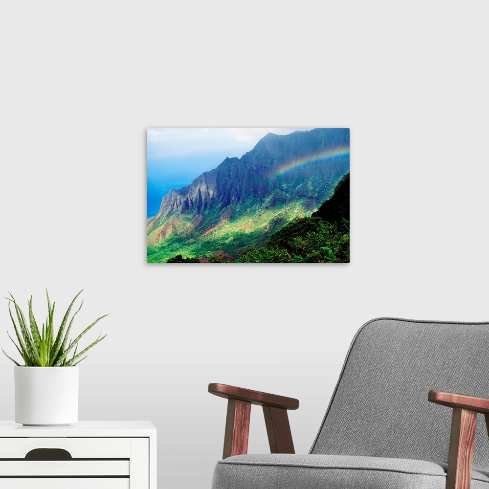 A modern room featuring Large canvas photo art of a rainbow in the middle of lush Hawaiian mountains.