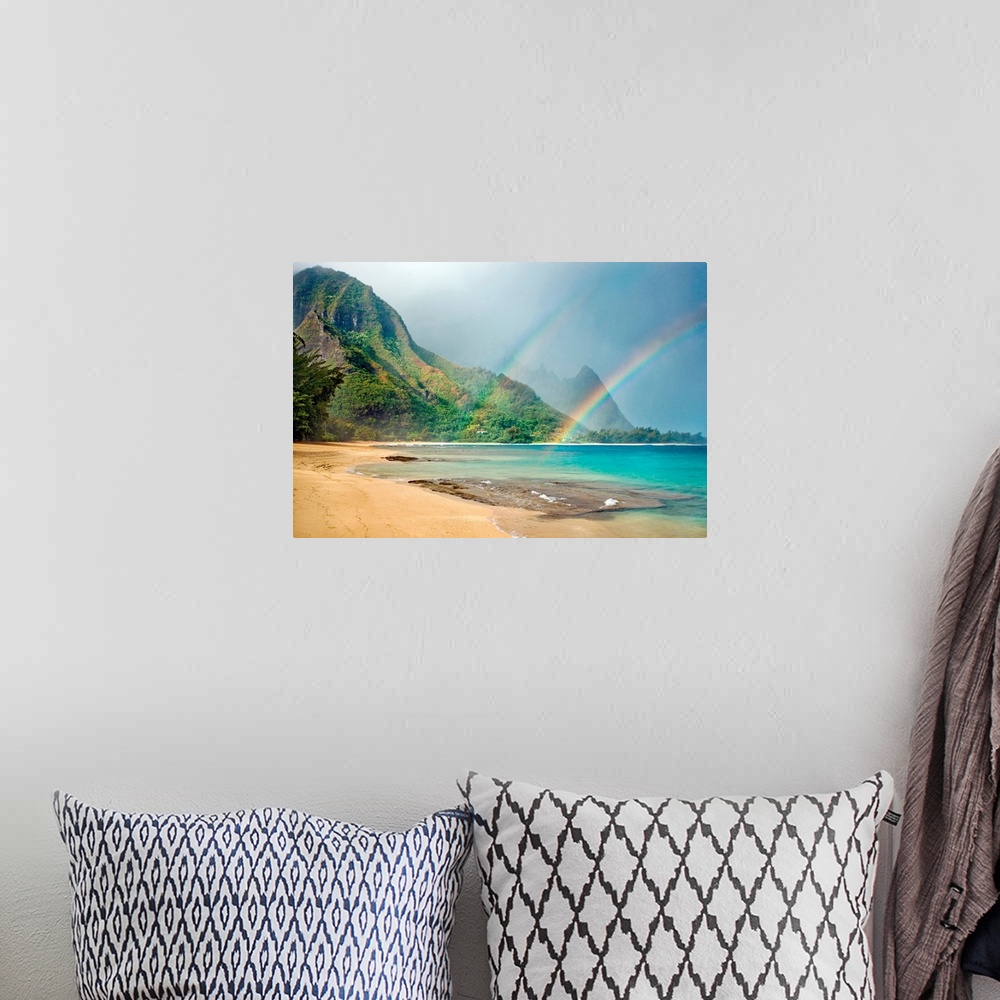A bohemian room featuring A landscape photograph with double rainbows on a tropical beach with mountains in the background.