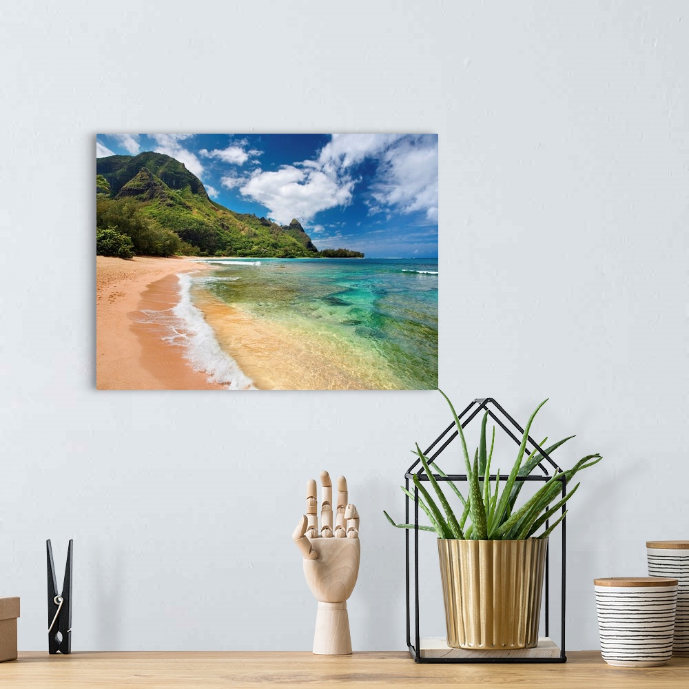 A bohemian room featuring Big photograph shows the clear waters of the Pacific Ocean slowly making their way to the sandy s...