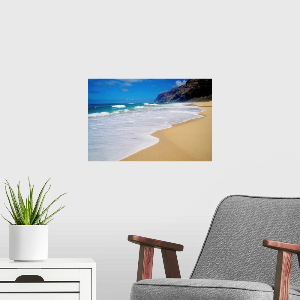 A modern room featuring Horizontal, oversized photograph of the shoreline at Polihale Beach in Kauai, Hawaii.  A cliff an...