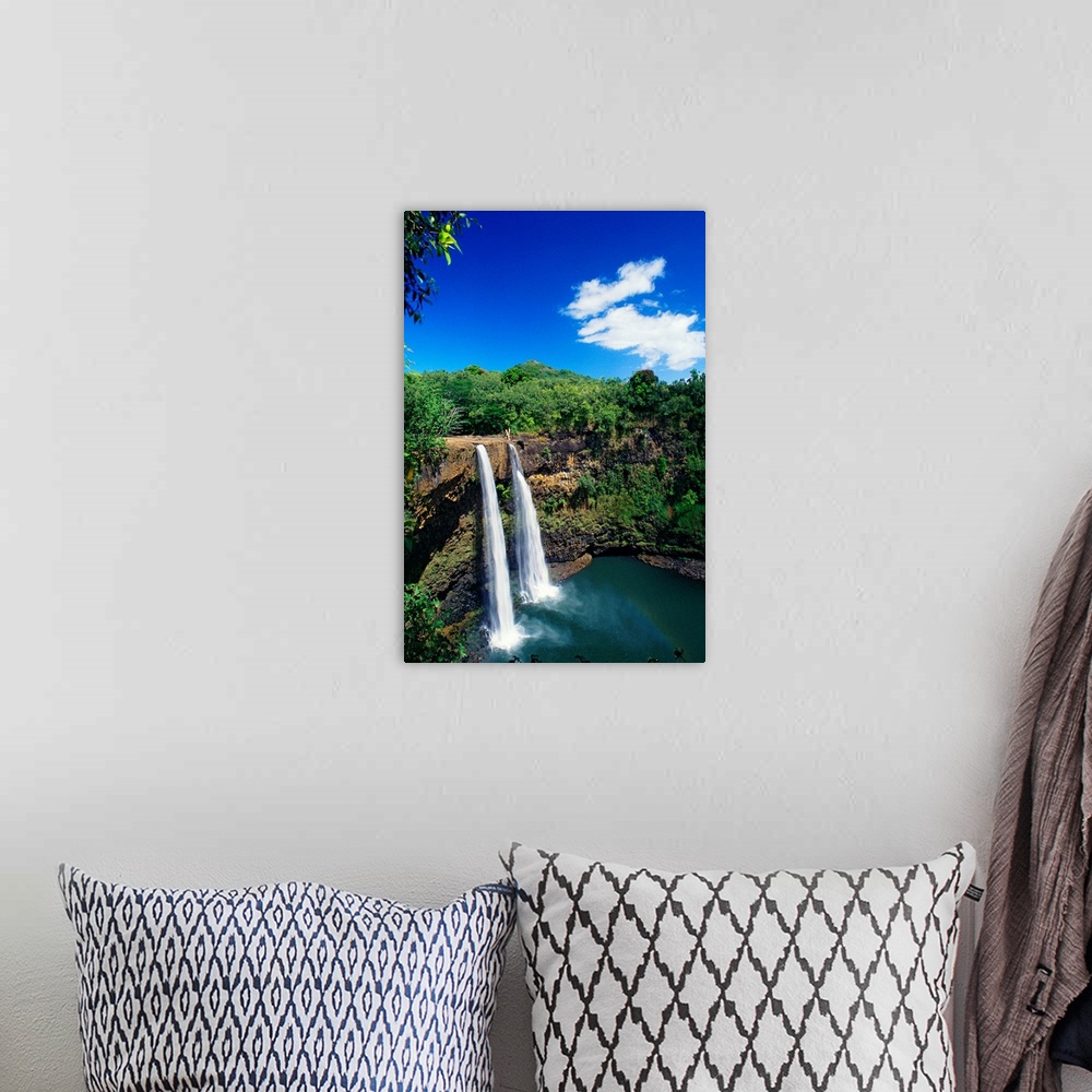 A bohemian room featuring Tall canvas of two waterfalls right next to each other sending water down to the lake below in Ha...