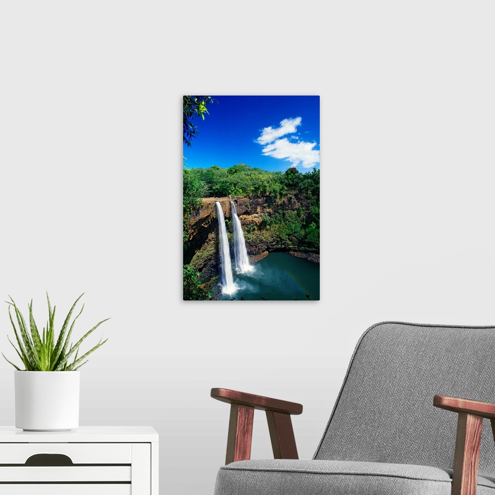 A modern room featuring Tall canvas of two waterfalls right next to each other sending water down to the lake below in Ha...