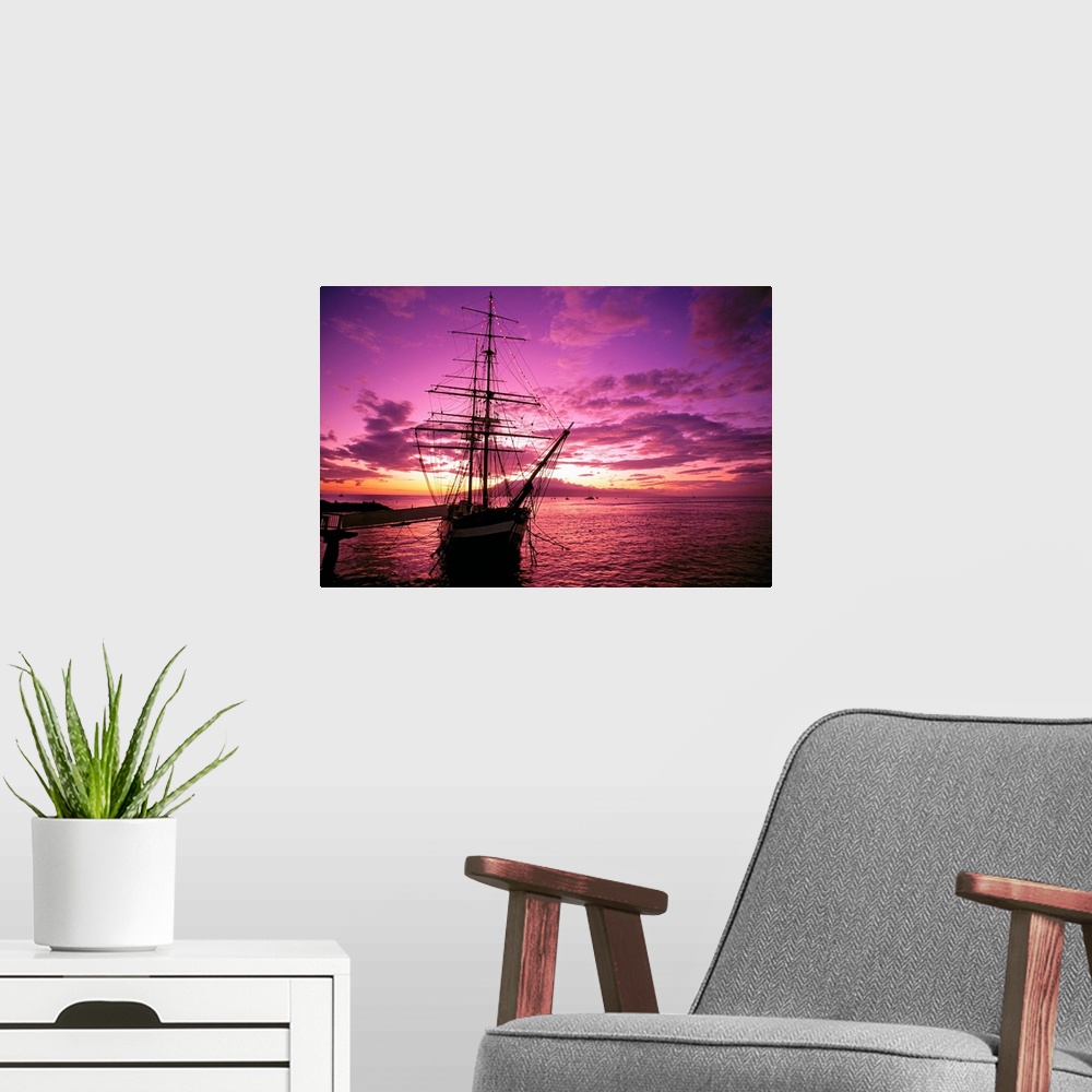 A modern room featuring Landscape photograph of a silhouetted Carthaginian ship in the waters of Lahaina Harbor, beneath ...