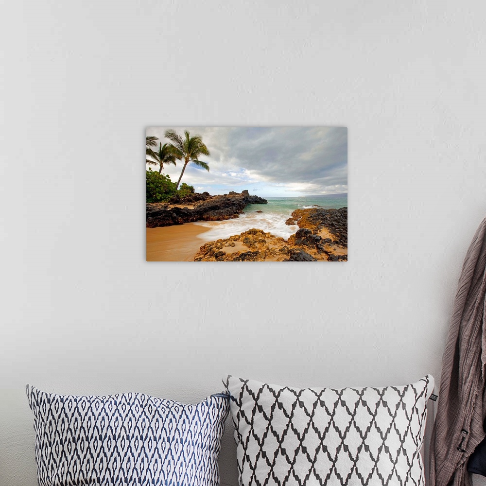A bohemian room featuring Photograph of a sandy break in the rocky coast as water rushes in to the cove with palm trees on ...