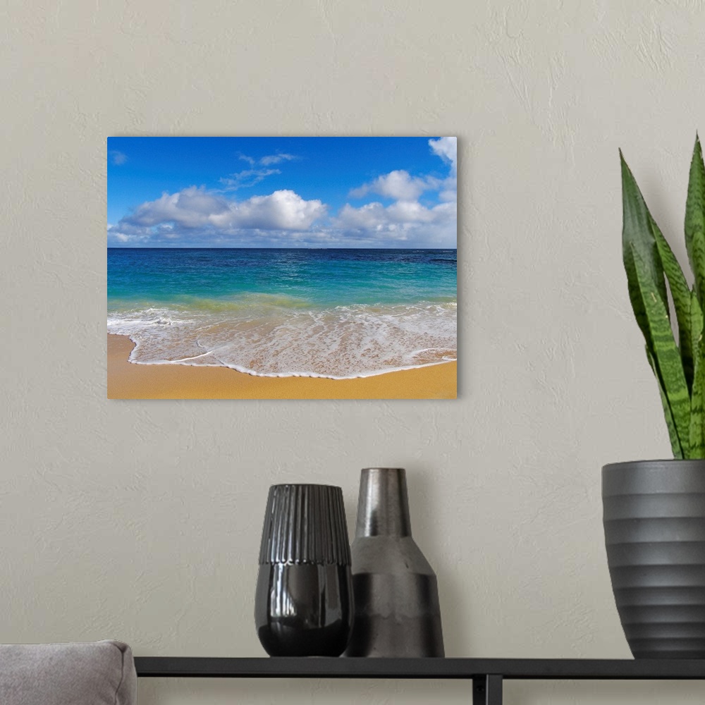 A modern room featuring Photograph of ocean washing up onto beach creating sea foam under a cloudy sky.