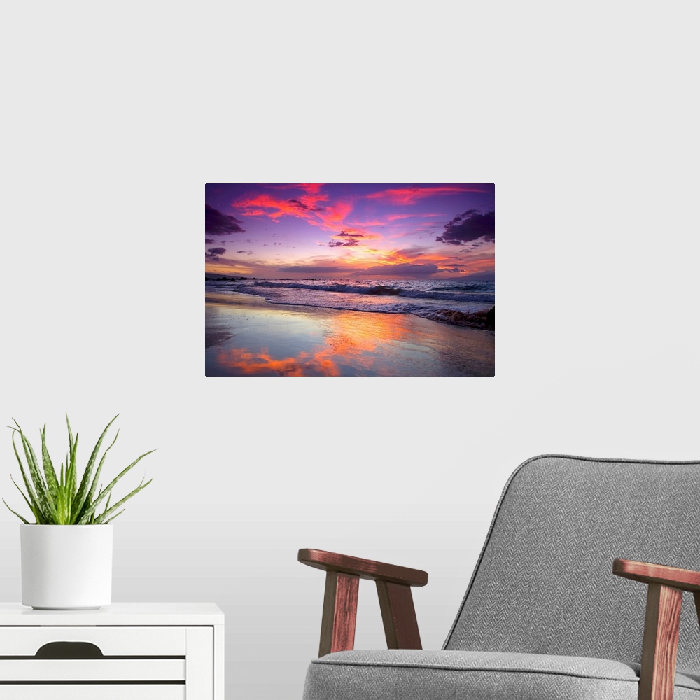 A modern room featuring Large photograph of waves crashing on Maui shore  as the sun sets behind the clouds.