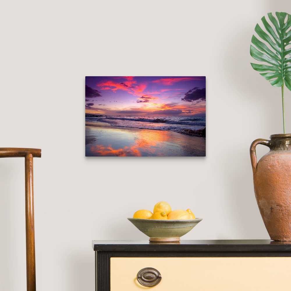 A traditional room featuring Large photograph of waves crashing on Maui shore  as the sun sets behind the clouds.