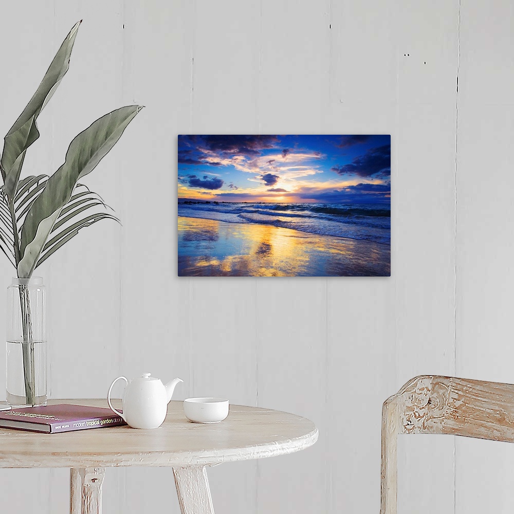 A farmhouse room featuring Horizontal photograph on a large wall hanging of a vivid sunset glowing through clouds, over the ...