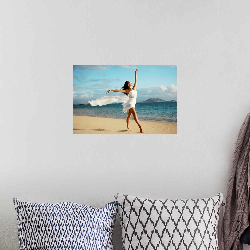 A bohemian room featuring Big canvas of a woman with a white sheets wrapped around her poses on a Hawaiian beach.