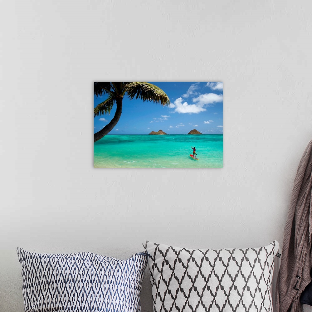 A bohemian room featuring Landscape photograph on a large canvas of a woman on a paddle board in the clear blue waters of L...