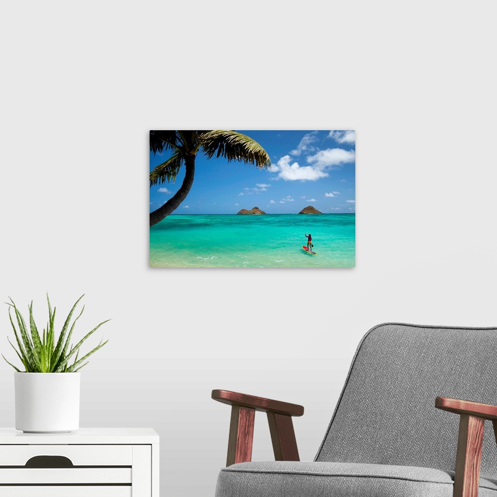 A modern room featuring Landscape photograph on a large canvas of a woman on a paddle board in the clear blue waters of L...