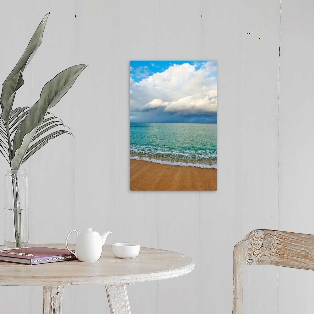 A farmhouse room featuring This photograph is taken on a beach in Hawaii of immense clouds that hang in the sky over a teal ...