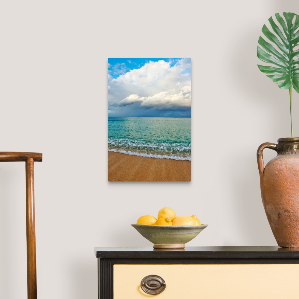 A traditional room featuring This photograph is taken on a beach in Hawaii of immense clouds that hang in the sky over a teal ...