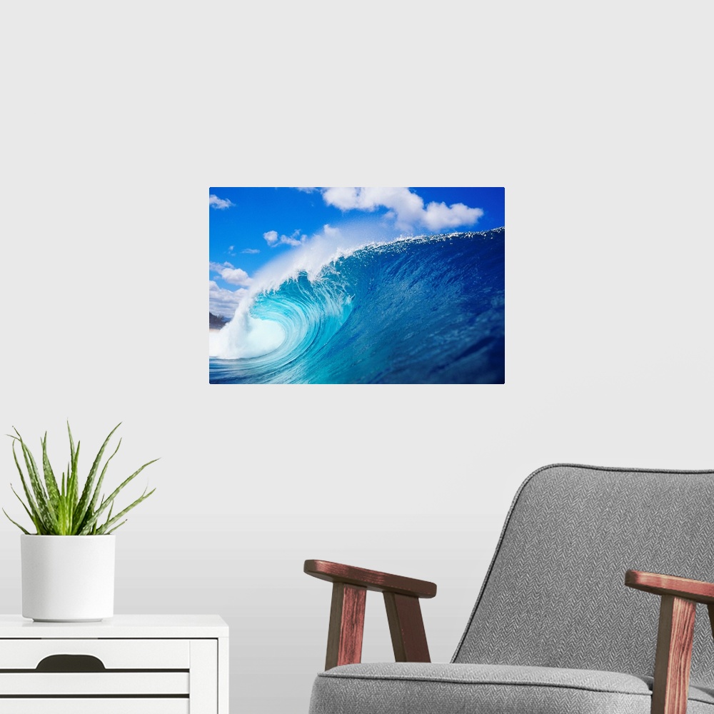 A modern room featuring Photograph taken from the side view of a large wave that has begun to curl.