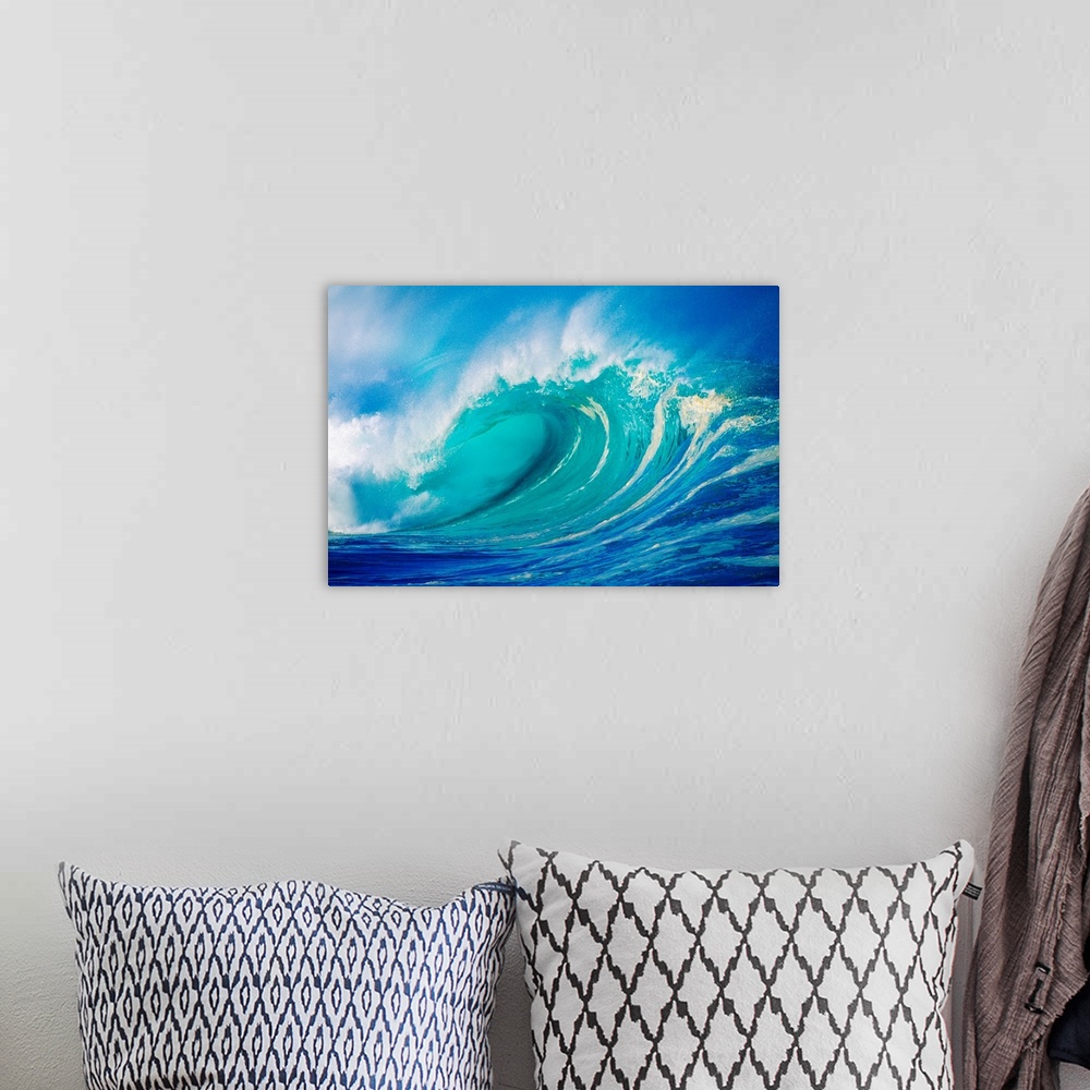 A bohemian room featuring Big photograph showcases a giant wave after it has curled and now prepares to break against the s...