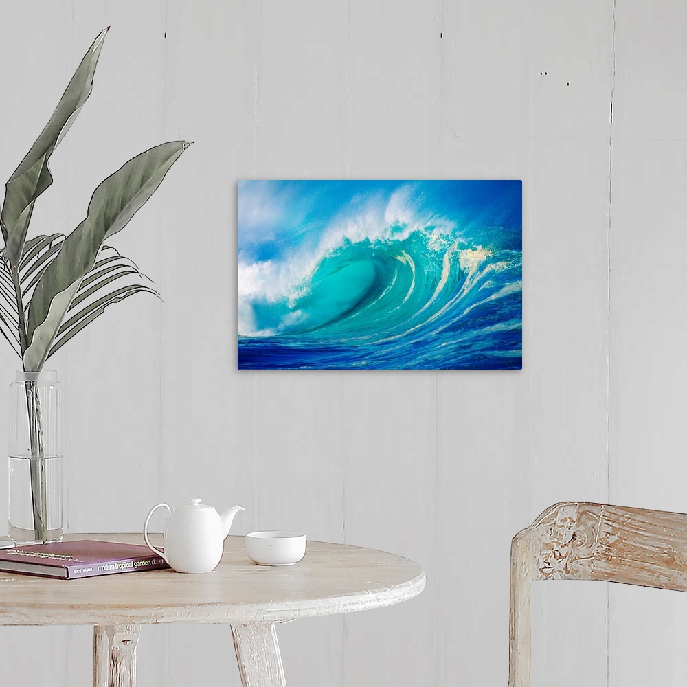 A farmhouse room featuring Big photograph showcases a giant wave after it has curled and now prepares to break against the s...