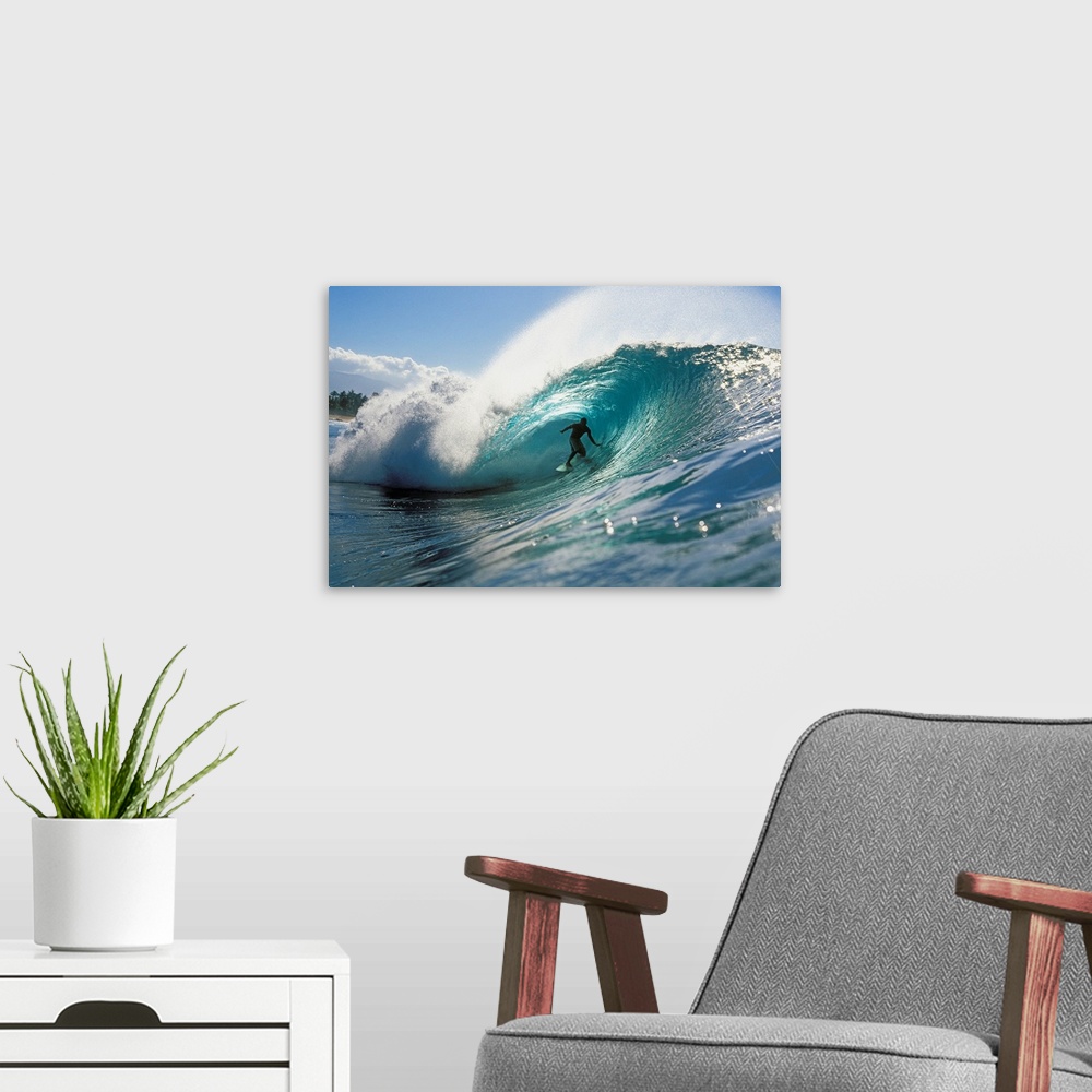 A modern room featuring Oversized, landscape photograph of a surfer riding down the center of Pipeline Wave, in the blue ...