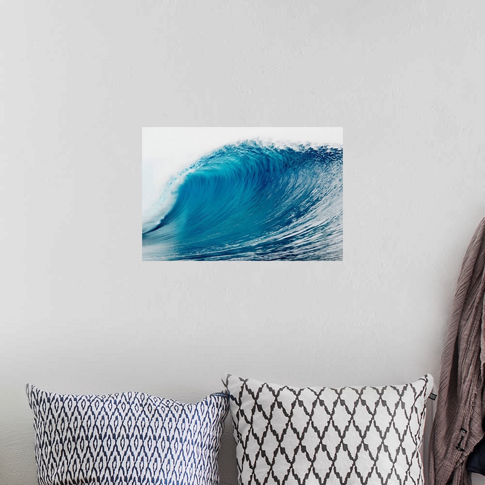 A bohemian room featuring A large wave is photographed as it begins to curl and break in the ocean.