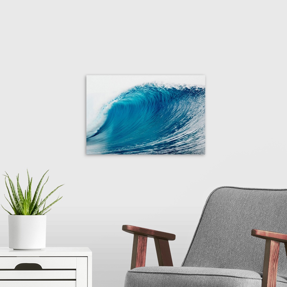A modern room featuring A large wave is photographed as it begins to curl and break in the ocean.