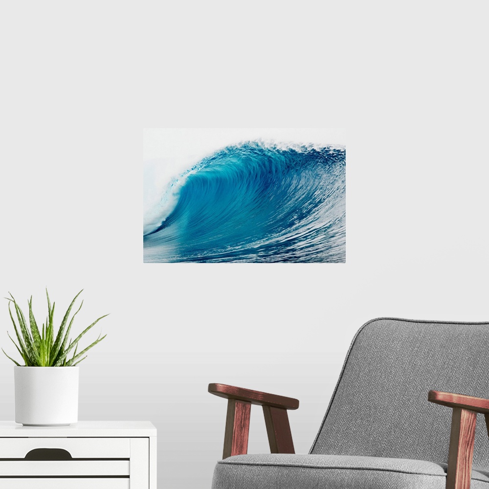 A modern room featuring A large wave is photographed as it begins to curl and break in the ocean.