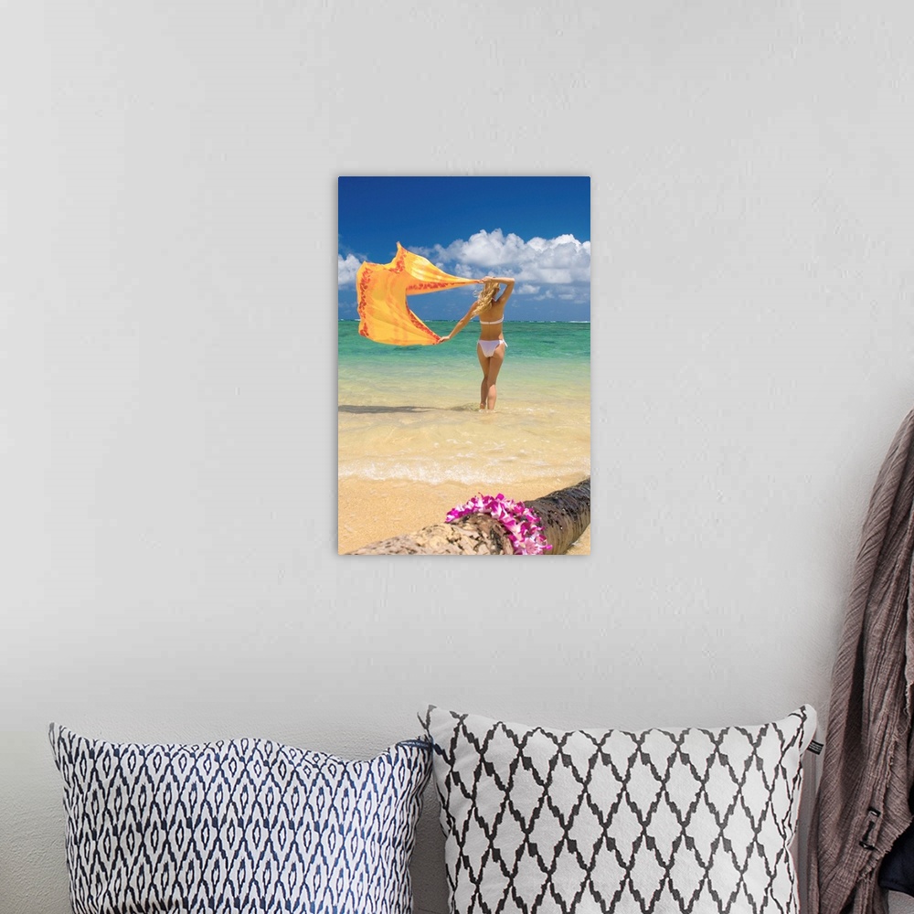 A bohemian room featuring Hawaii, Oahu, Punaluu Beach, Young Woman Standing In Ocean Holding Pareo