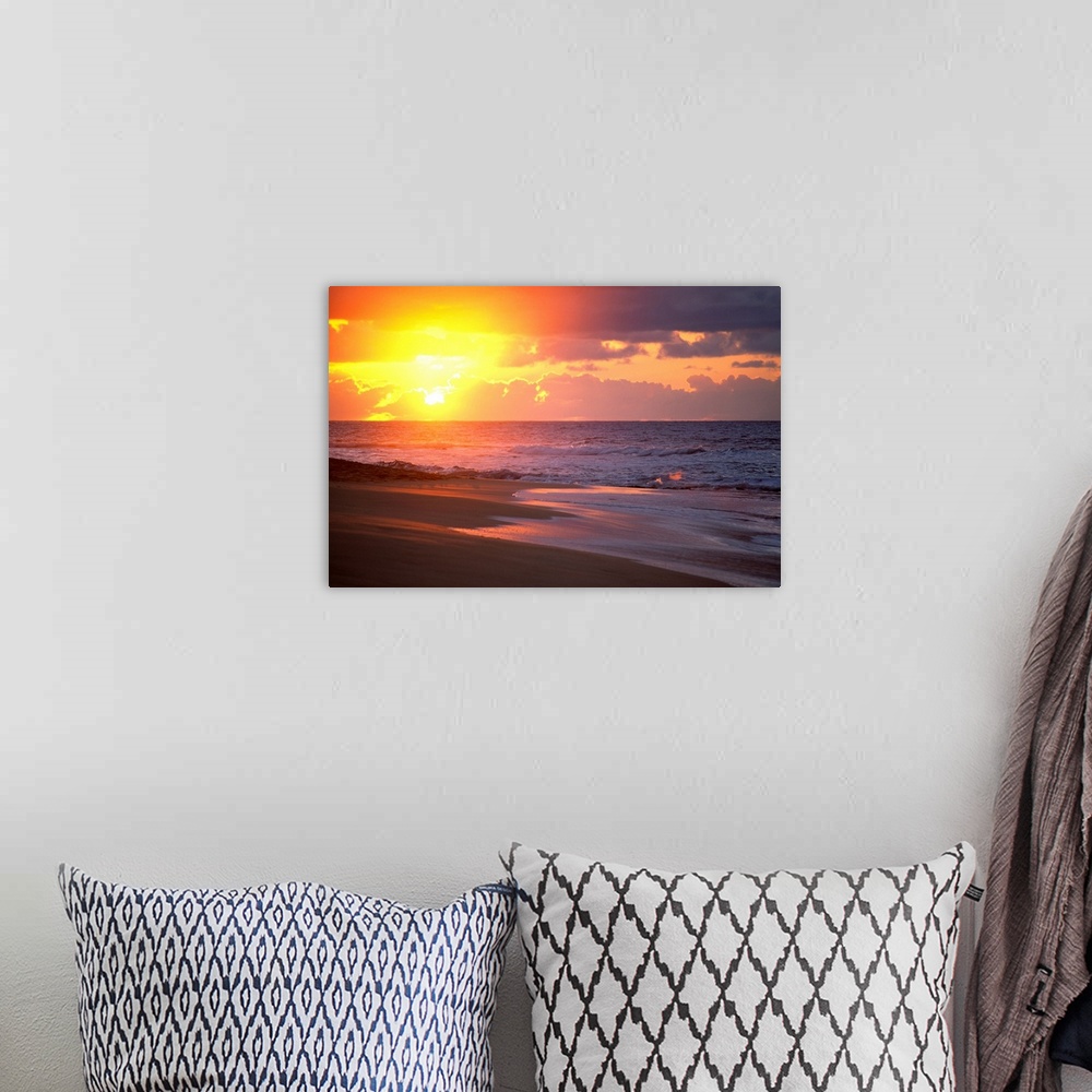 A bohemian room featuring Big canvas print of waves crashing on to a beach with the sun rising in the background.
