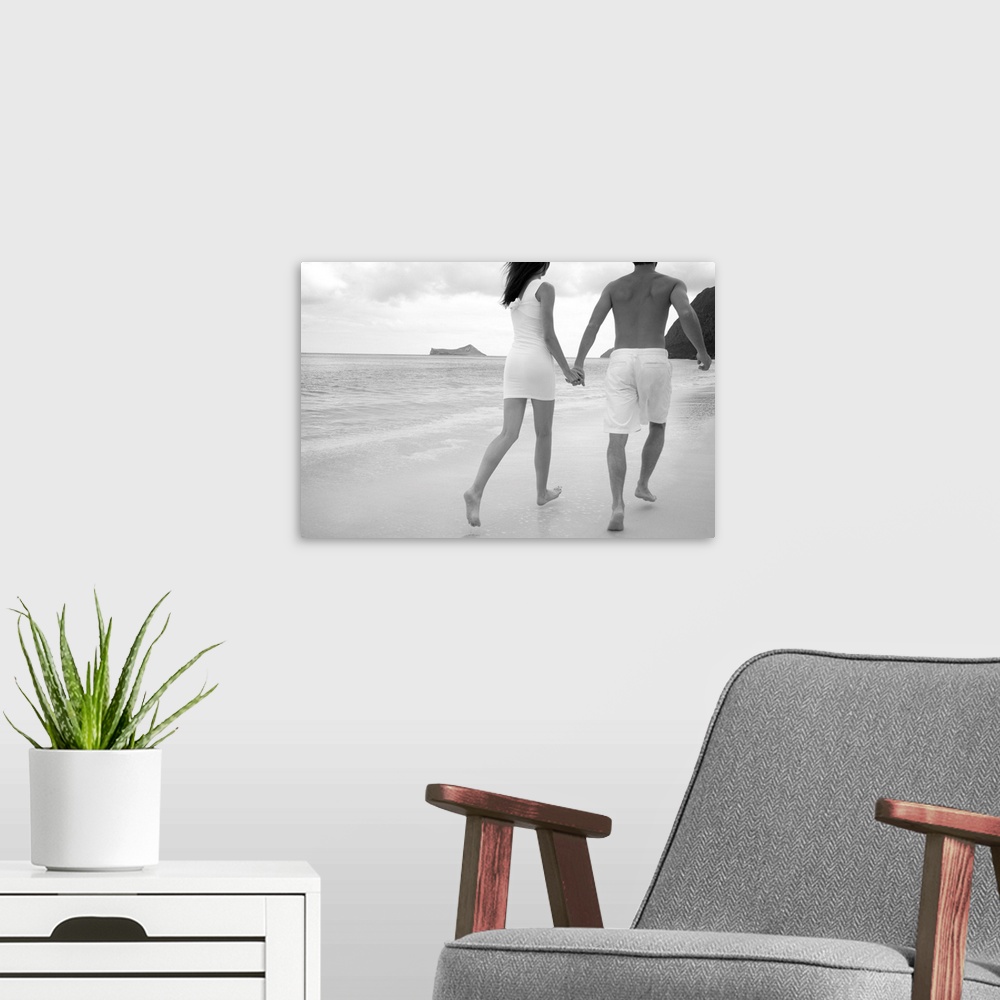 A modern room featuring Hawaii, Oahu, Waimanalo, Young Couple Holding Hands Running Together Along The Beach