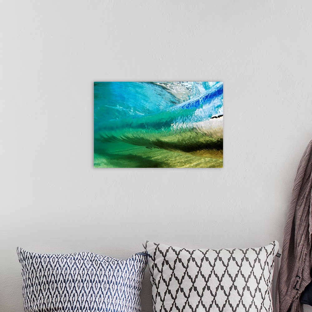 A bohemian room featuring Canvas photo art of a wave about to crash seen from underneath the water.