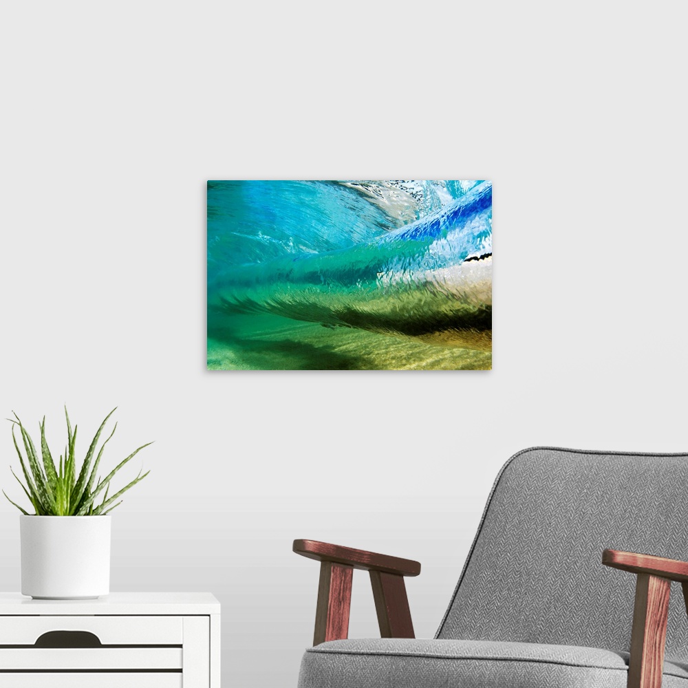 A modern room featuring Canvas photo art of a wave about to crash seen from underneath the water.