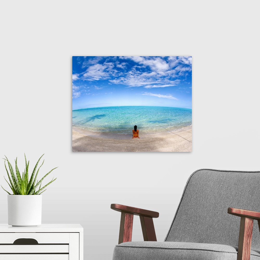 A modern room featuring Hawaii, Woman Laying On The Beach In Remote Tropical Location