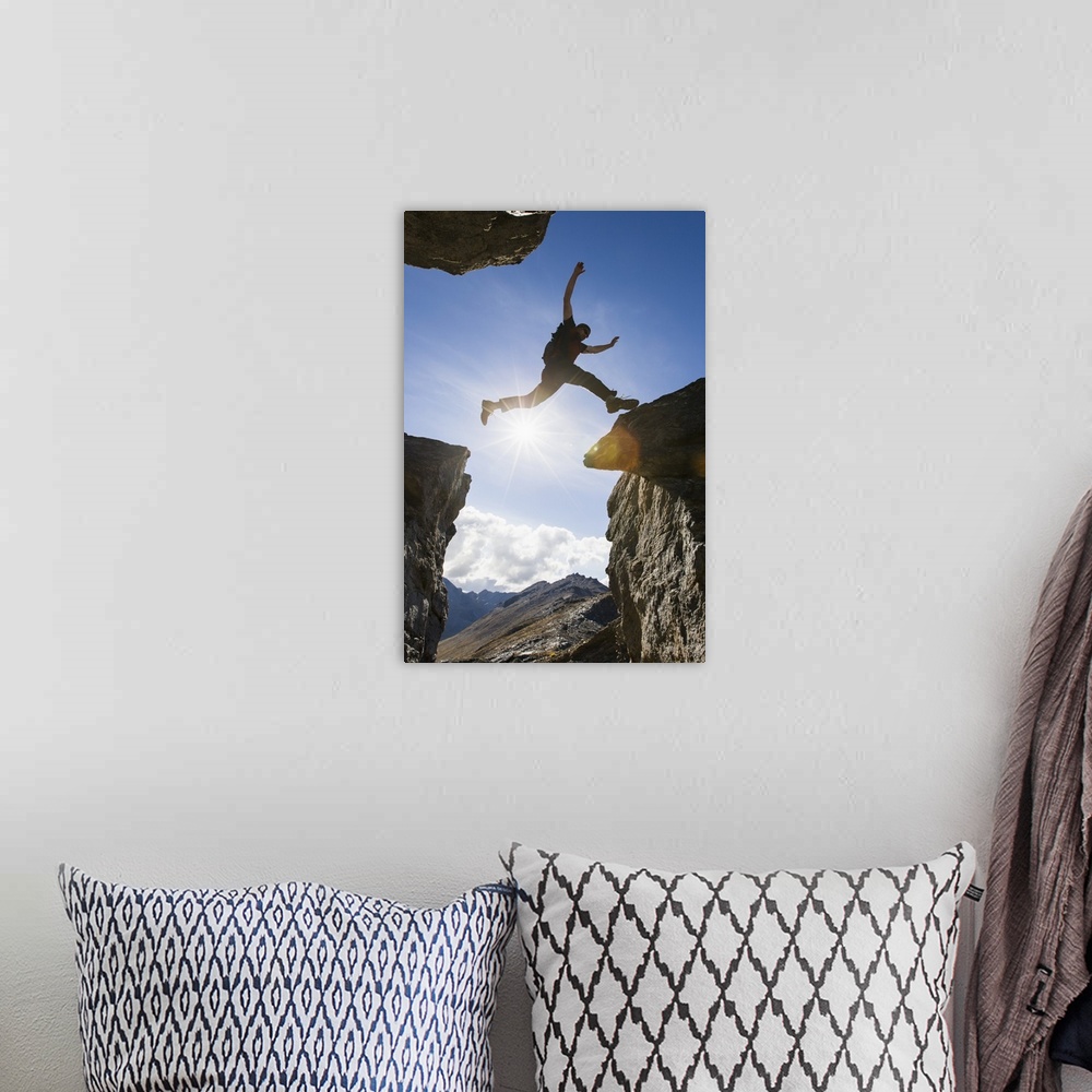A bohemian room featuring Backlit View Of Hiker Leaping Between Rocks Near Noatak River In The Brooks Range, Gates Of The A...