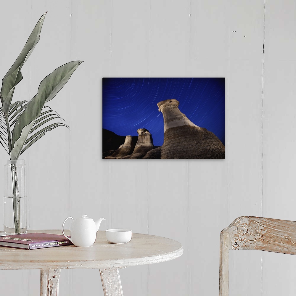 A farmhouse room featuring Hoodoos And Star Trails In The Sky; Drumheller, Alberta, Canada